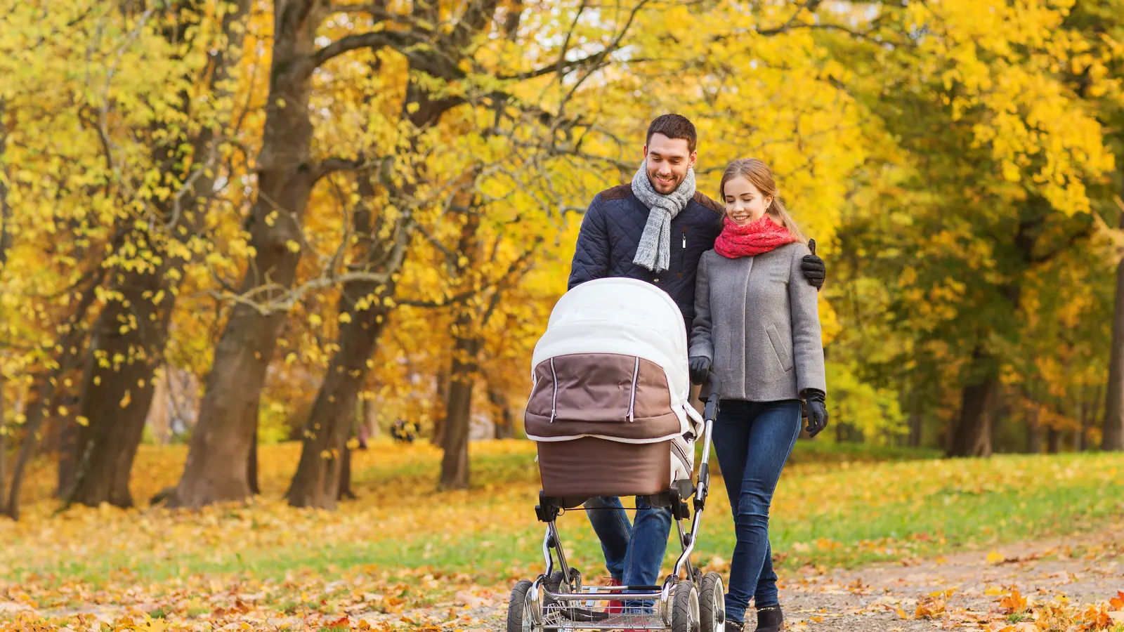 Föräldrar med barnvagn i parken